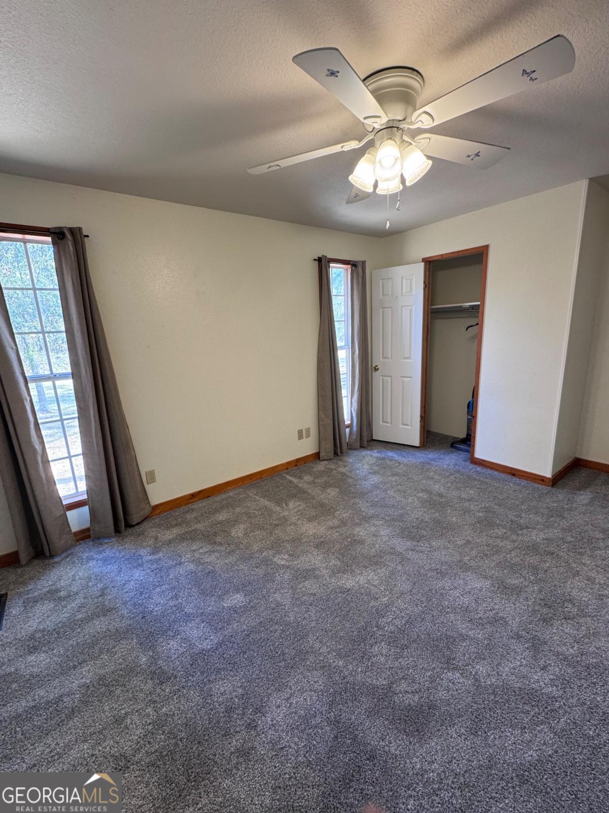 347 Benton Powell Road Uvalda, GA 30473 - Photo 16 of 39 an empty room with windows and fan