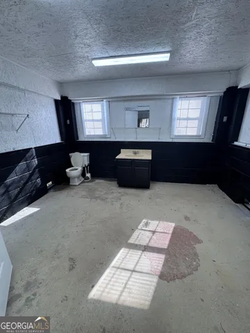 a view of a house with a yard and a fountain