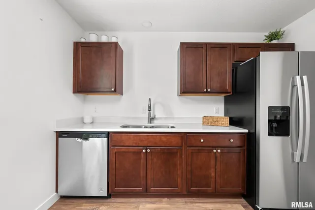 a kitchen with stainless steel appliances granite countertop a refrigerator and a sink