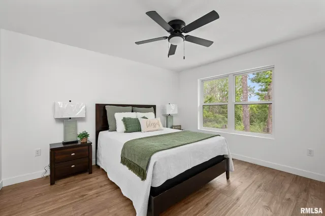 a bedroom with a large bed and a large window