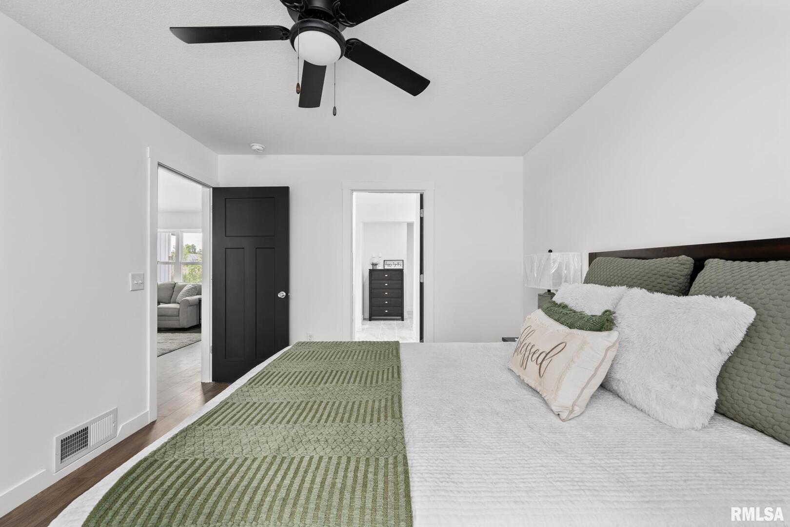 813 Williams Way Carbon Cliff, IL 61239 - Photo 16 of 36 a bedroom with a large bed and ceiling fan