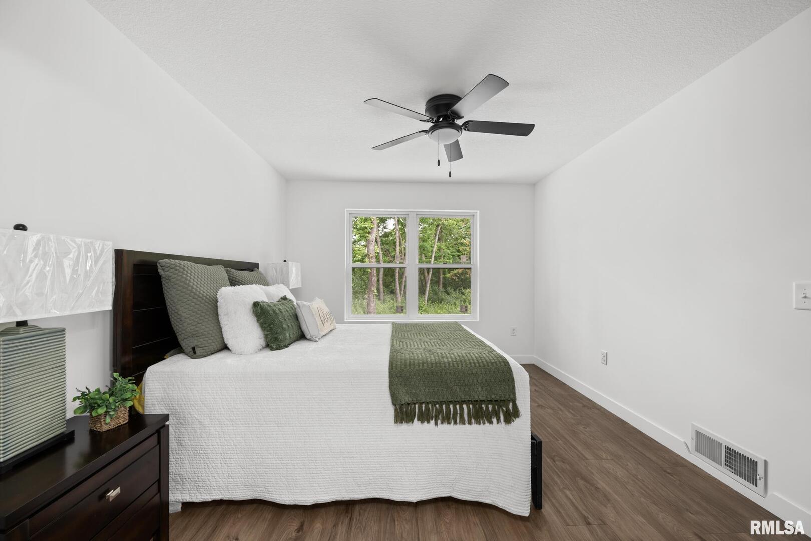 813 Williams Way Carbon Cliff, IL 61239 - Photo 17 of 36 a bedroom with a bed and wooden floor