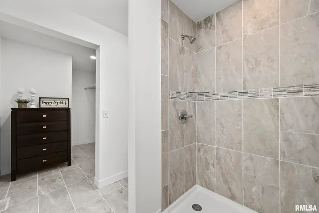 a bathroom with a sink vanity and shower