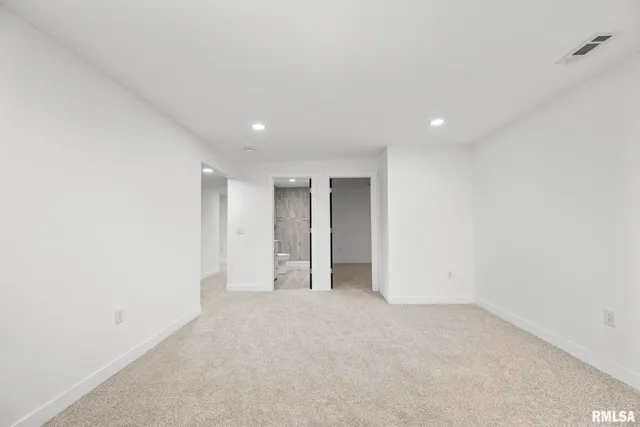 a bathroom with a granite countertop sink a toilet and shower