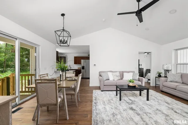 a living room with furniture wooden floor and a chandelier