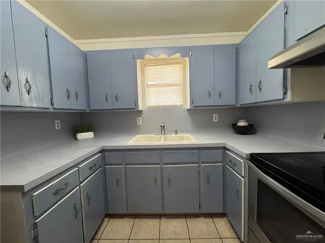 a kitchen with a sink cabinets and window