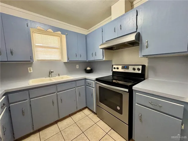 a kitchen with cabinets and stainless steel appliances