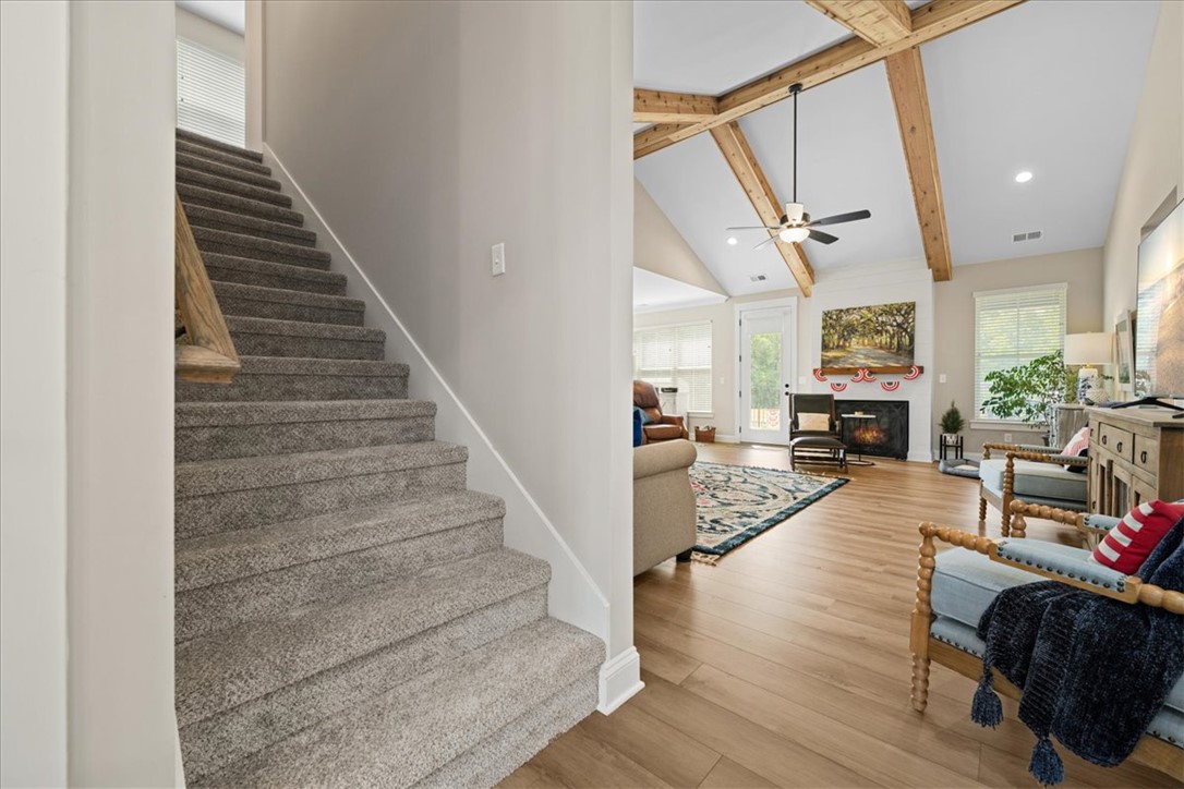 6834 Midway Road Pelzer, SC 29669 - Photo 38 of 50 This living room boasts high ceilings with exposed beams and hardwood flooring.