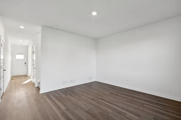 a view of a room with wooden floor
