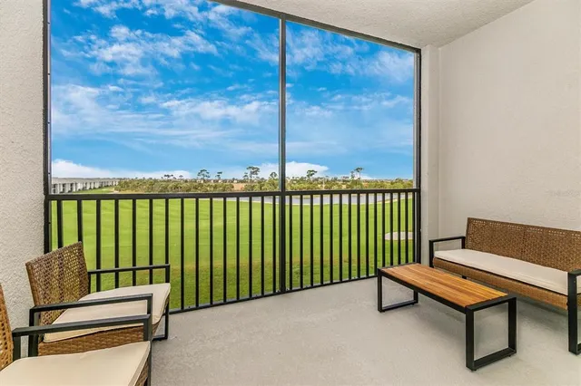 a view of a hallway with a livingroom and a bathroom with sink