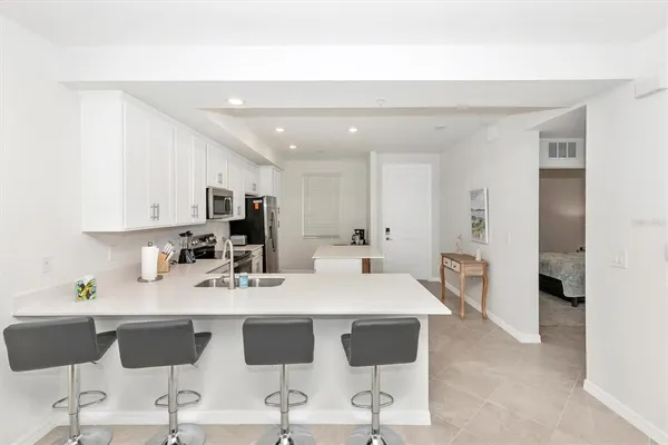a kitchen with a sink a stove a refrigerator and a refrigerator