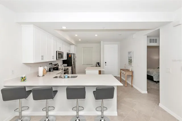 a kitchen with a sink a stove a refrigerator and a refrigerator