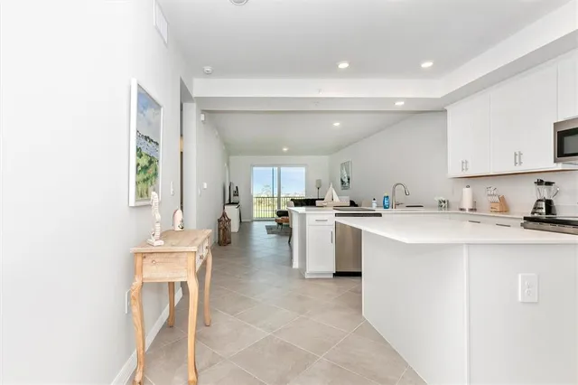 a living room with furniture a flat screen tv and a large window