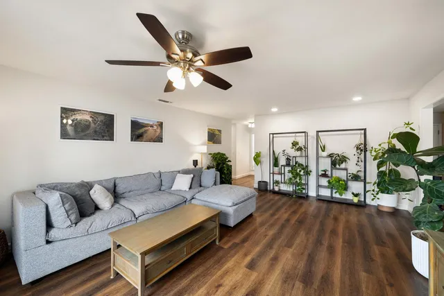 a living room with furniture and a wooden floor