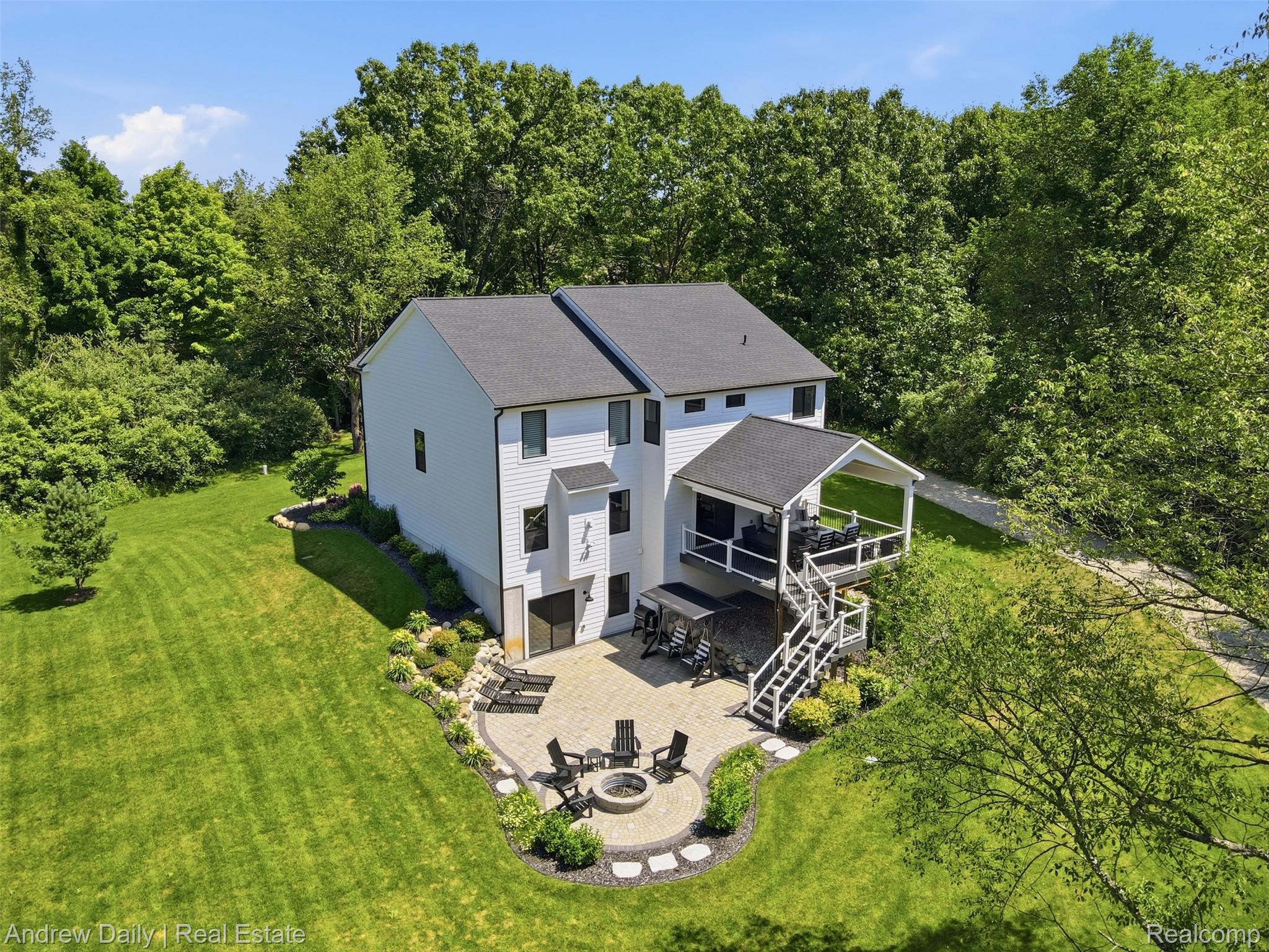 4661 Spears Road Pinckney, MI 48169 - Photo 53 of 56 Exterior featuring white siding, a covered deck with white railings, and a stone patio