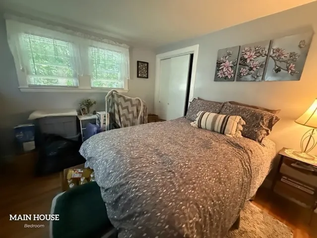 a bed sitting in a bedroom next to a window