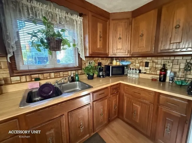 a kitchen with stainless steel appliances granite countertop a sink a stove and cabinets