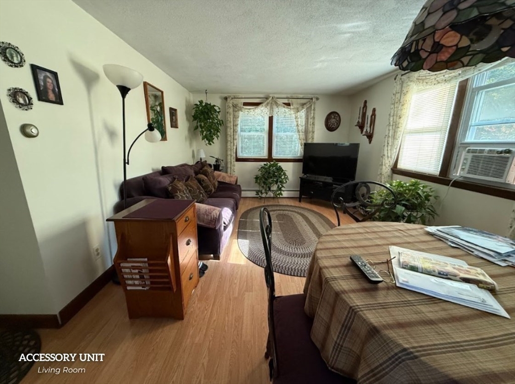 347 Ash Street Reading, MA 01867 - Photo 14 of 18 a living room with furniture and a fireplace
