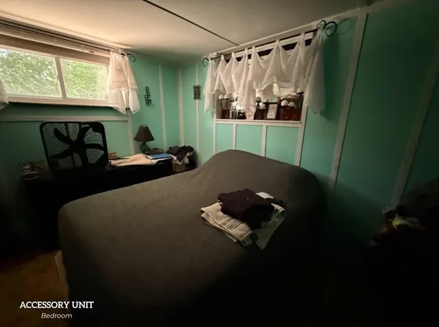 a bed sitting in a bedroom next to a window