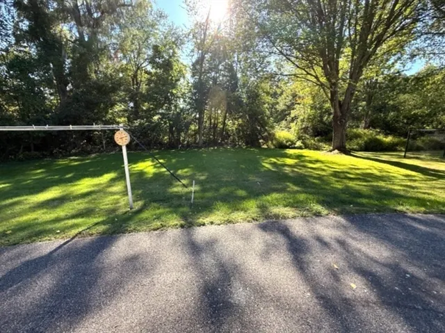 a view of a backyard with swimming pool