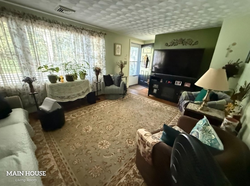 347 Ash Street Reading, MA 01867 - Photo 8 of 18 a living room with furniture and a flat screen tv
