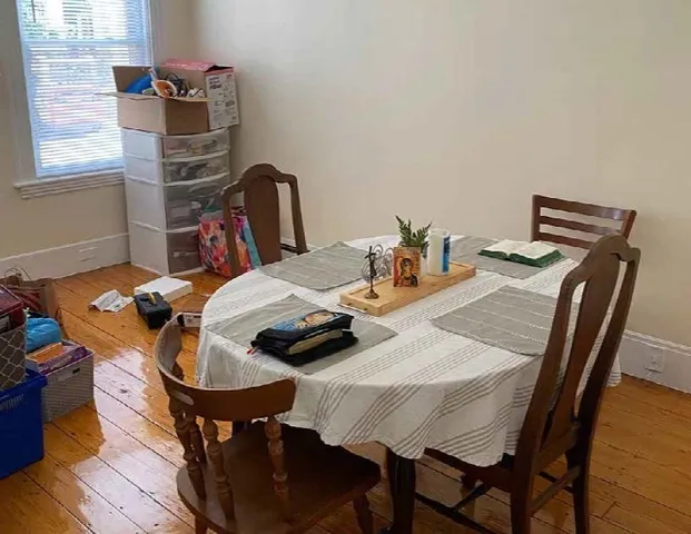 a dining room with furniture and wooden floor