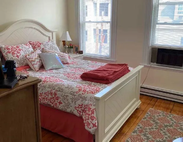 a bedroom with a bed and a window