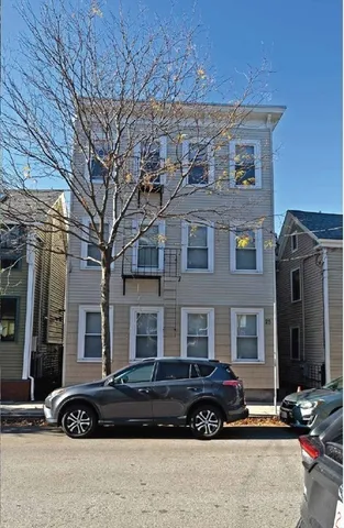 a car parked in front of a brick building