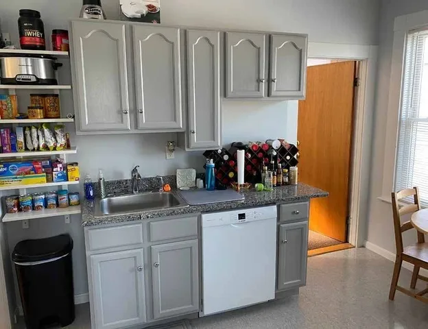 a kitchen with stainless steel appliances granite countertop a sink stove and cabinets
