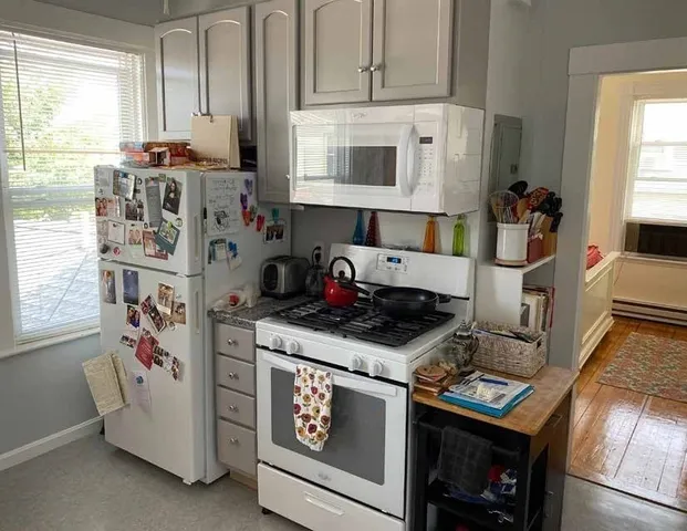a kitchen with stainless steel appliances granite countertop a stove and a microwave