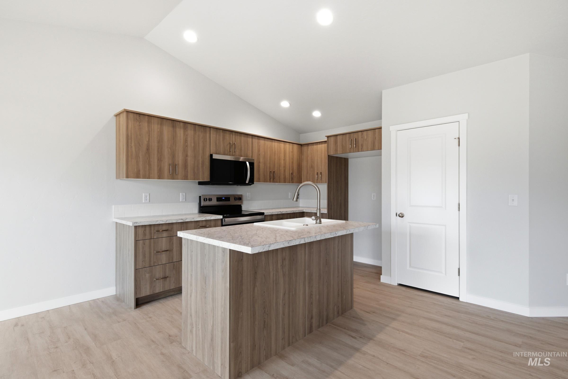16632 North Shorthorn Loop Nampa, ID 83651 - Photo 5 of 17 Contemporary kitchen with a central island featuring an undermount sink and gooseneck faucet