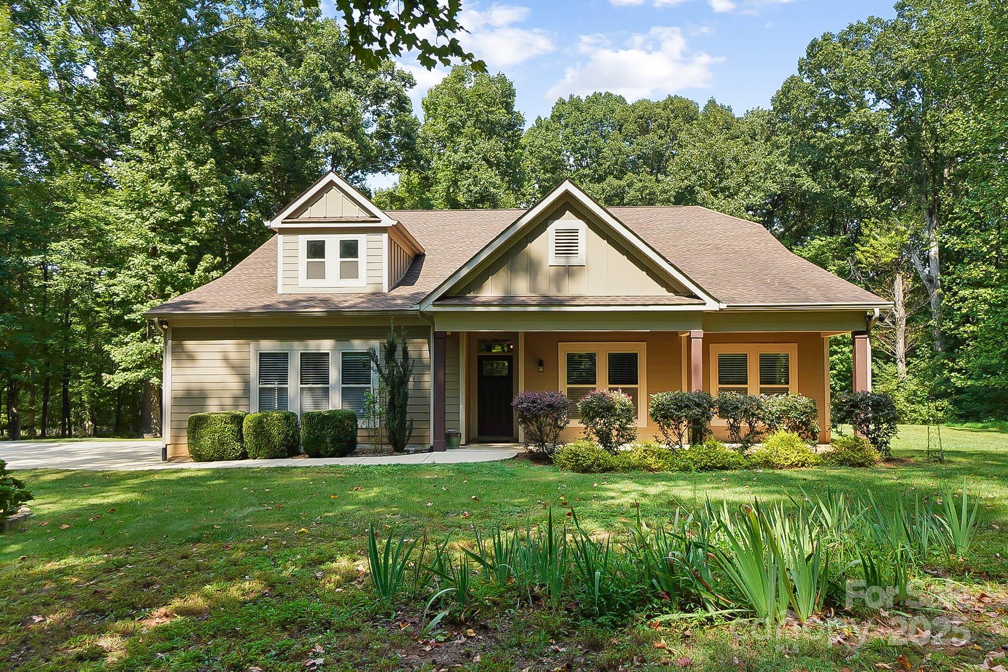 7305 Indian Trail Fairview Road Indian Trail, NC 28079 - Photo 1 of 48 a front view of a house with garden and trees