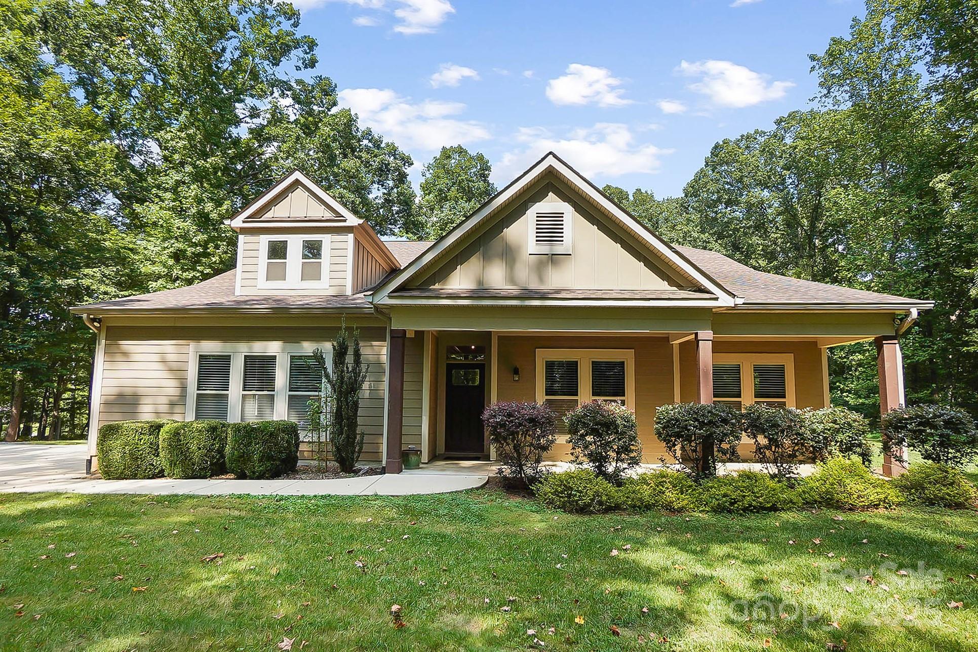 7305 Indian Trail Fairview Road Indian Trail, NC 28079 - Photo 11 of 48 a front view of a house with a yard and porch
