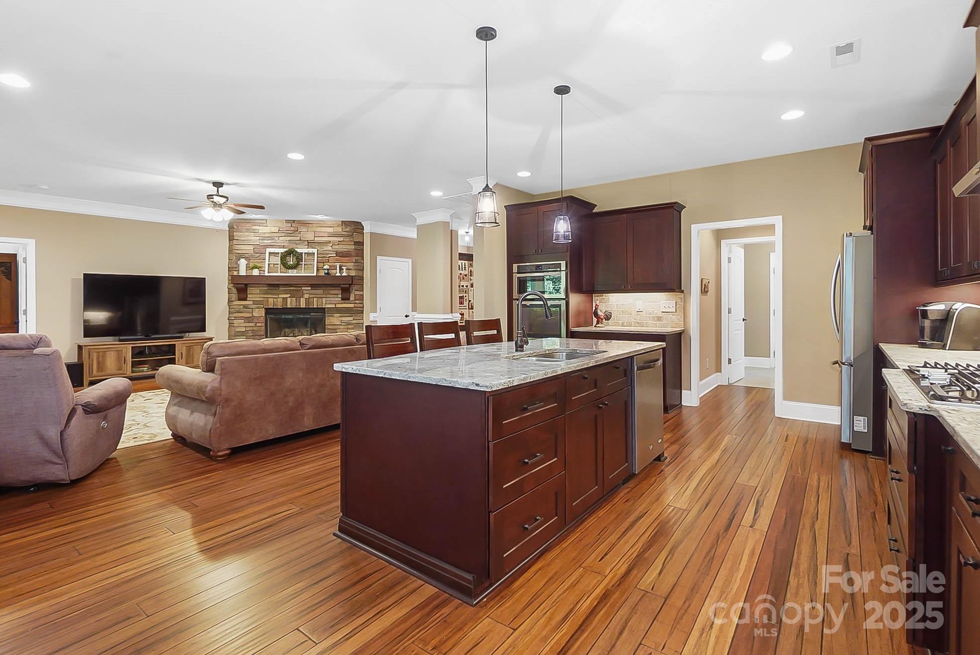 7305 Indian Trail Fairview Road Indian Trail, NC 28079 - Photo 17 of 48 a large kitchen with stainless steel appliances granite countertop a lot of cabinets and wooden floor