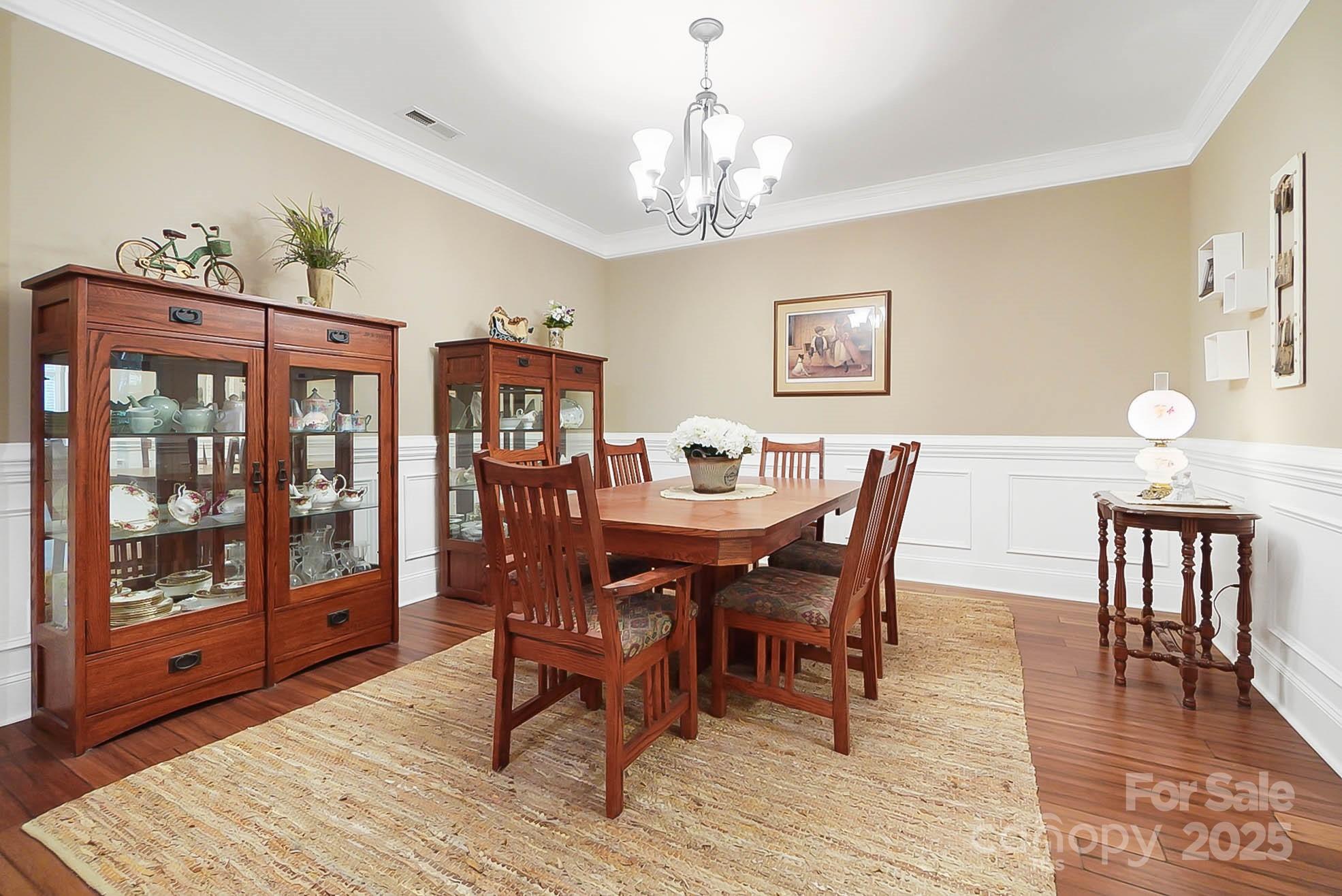 7305 Indian Trail Fairview Road Indian Trail, NC 28079 - Photo 20 of 48 a view of a dining room with furniture wooden floor and chandelier