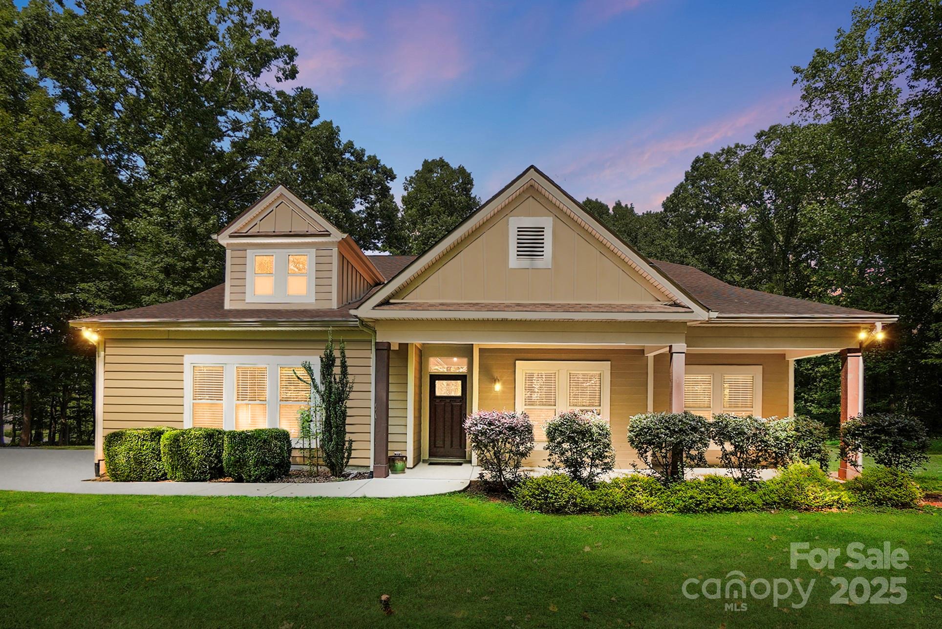 7305 Indian Trail Fairview Road Indian Trail, NC 28079 - Photo 2 of 48 a front view of a house with a garden and plants