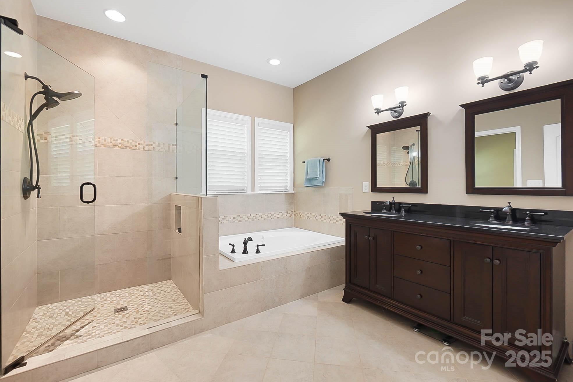 7305 Indian Trail Fairview Road Indian Trail, NC 28079 - Photo 26 of 48 a spacious bathroom with a tub sink and mirror