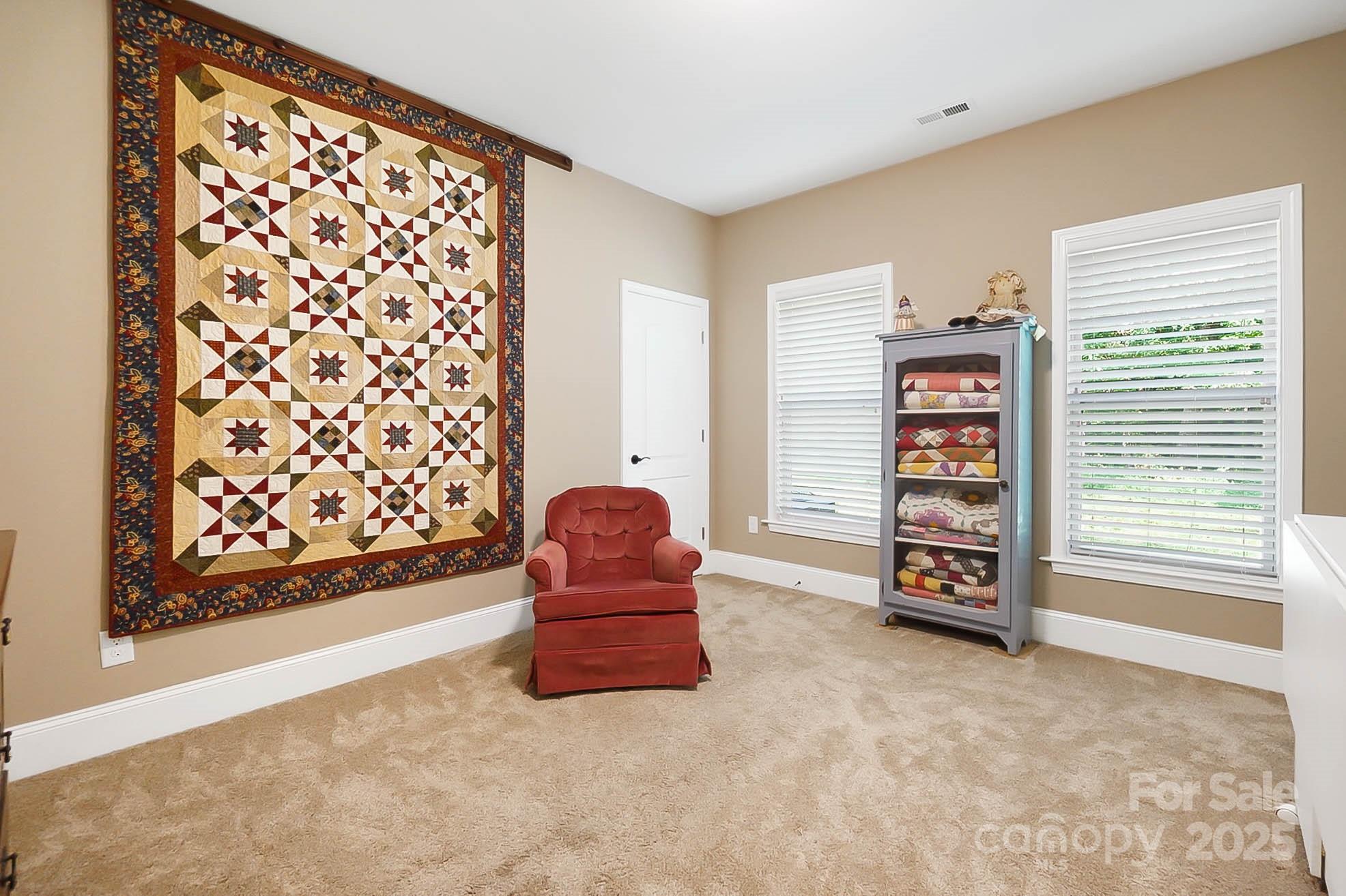 7305 Indian Trail Fairview Road Indian Trail, NC 28079 - Photo 28 of 48 a living room with furniture and a bookshelf with wooden floor