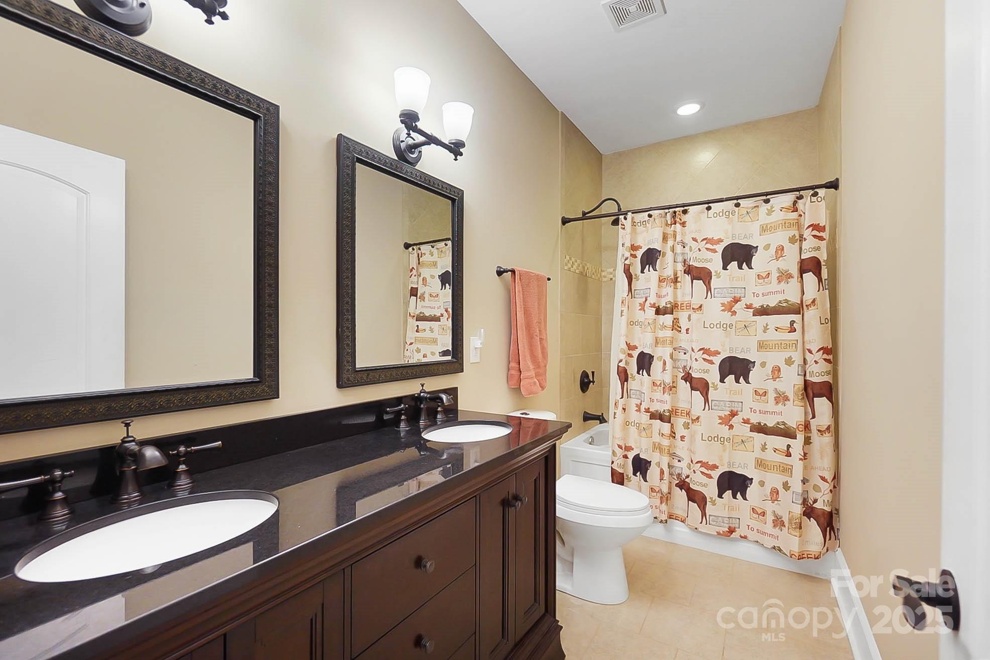 7305 Indian Trail Fairview Road Indian Trail, NC 28079 - Photo 30 of 48 a bathroom with a double vanity sink toilet mirror and shower