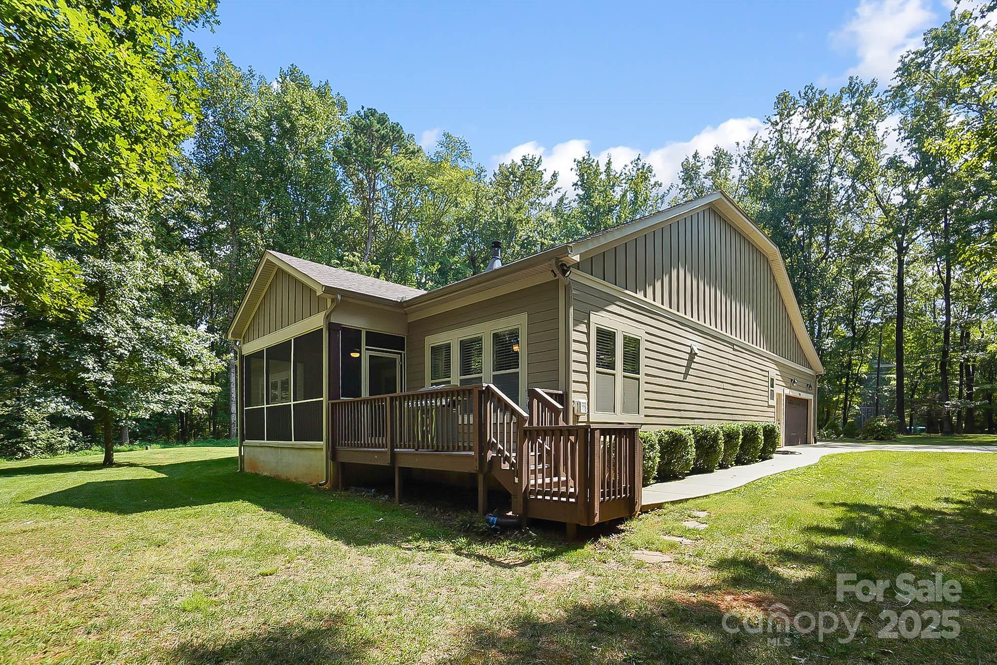 7305 Indian Trail Fairview Road Indian Trail, NC 28079 - Photo 36 of 48 a view of a house with a yard deck and a large tree