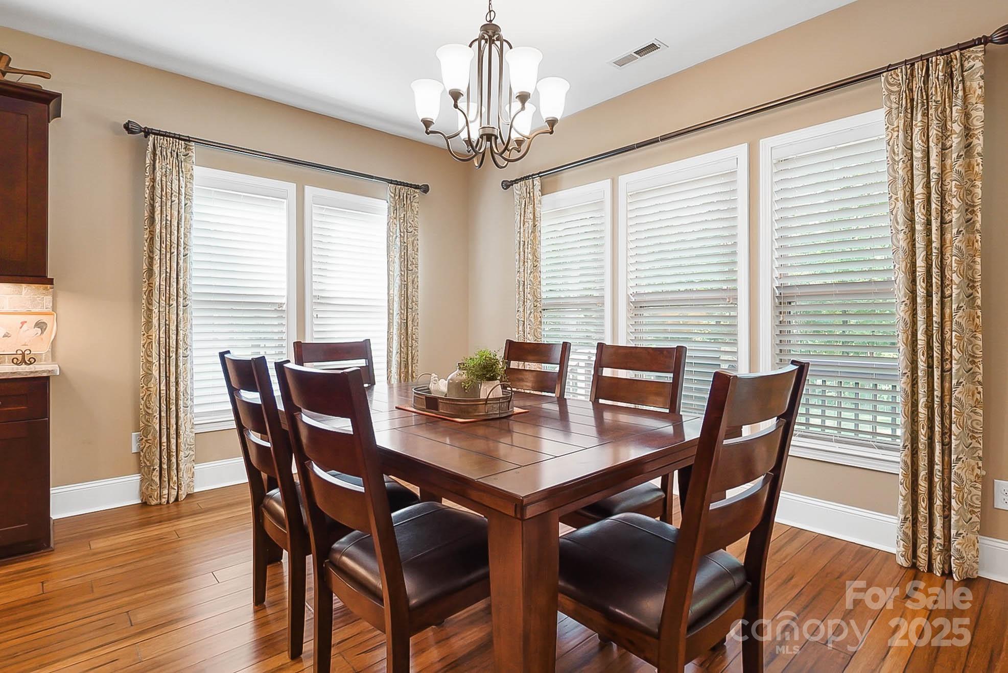 7305 Indian Trail Fairview Road Indian Trail, NC 28079 - Photo 7 of 48 a view of a dining room with furniture window and wooden floor