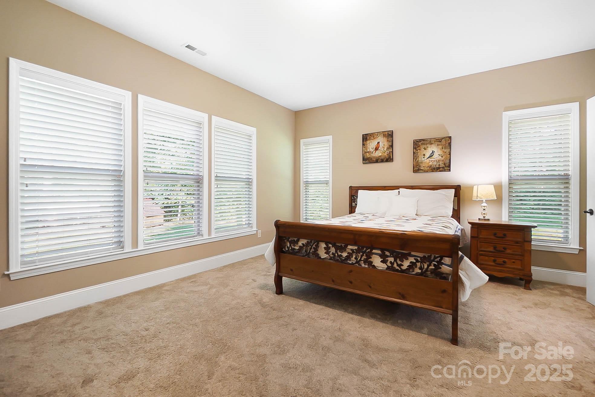 7305 Indian Trail Fairview Road Indian Trail, NC 28079 - Photo 9 of 48 a large bedroom with a bed and wooden floor