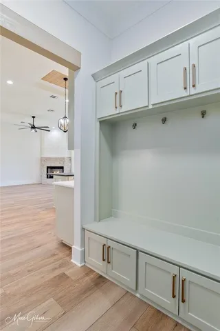 a kitchen with a stove chandelier and wooden floor