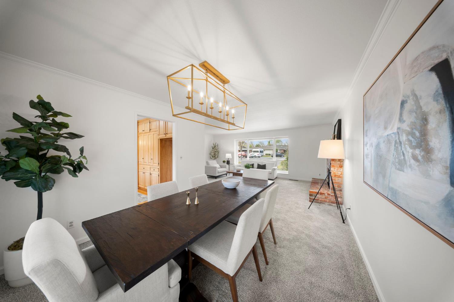 929 Terrace Place Modesto, CA 95350 - Photo 11 of 35 a living room with furniture a chandelier and a potted plant