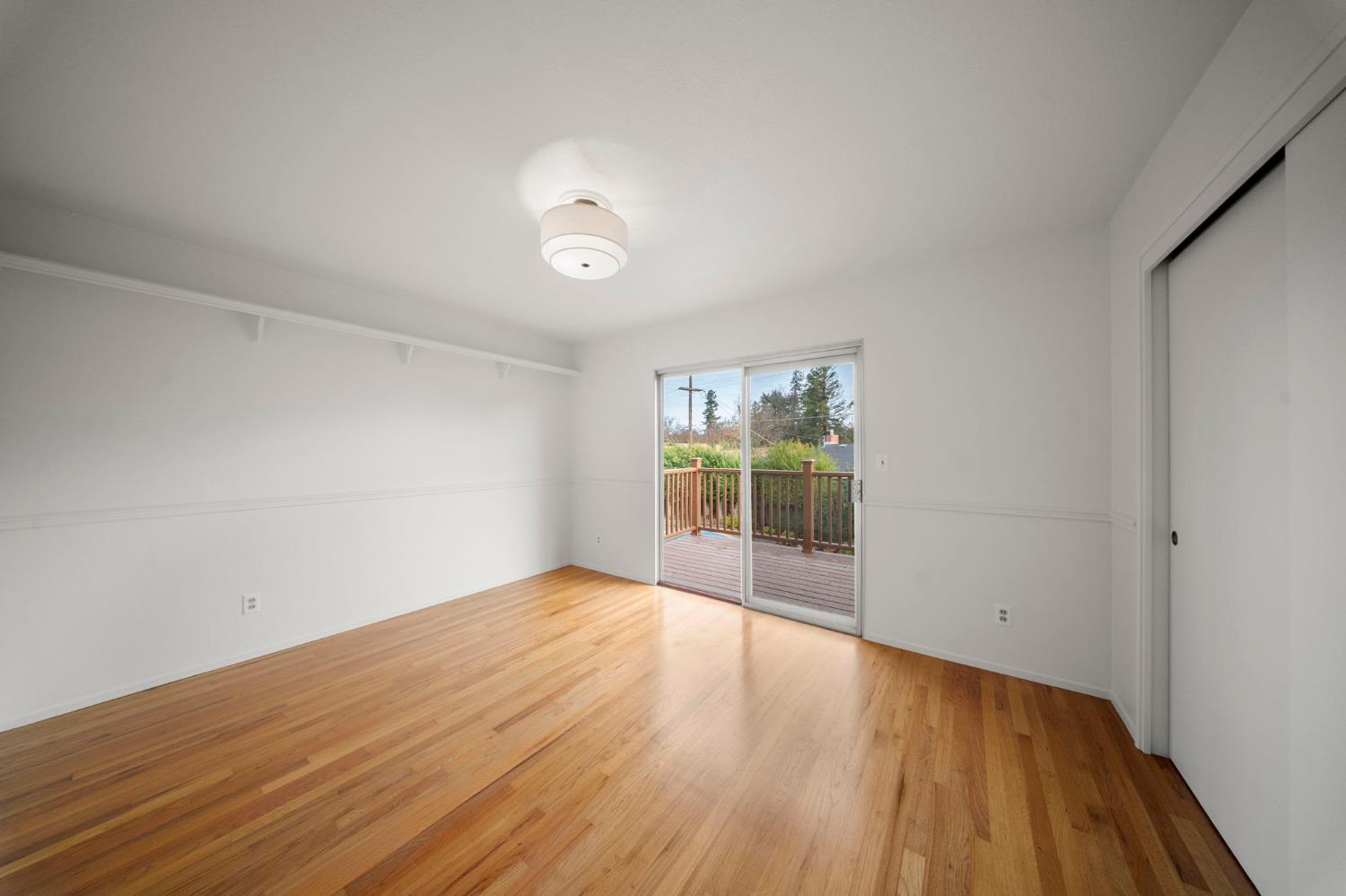 929 Terrace Place Modesto, CA 95350 - Photo 21 of 35 wooden floor in an empty room with a window