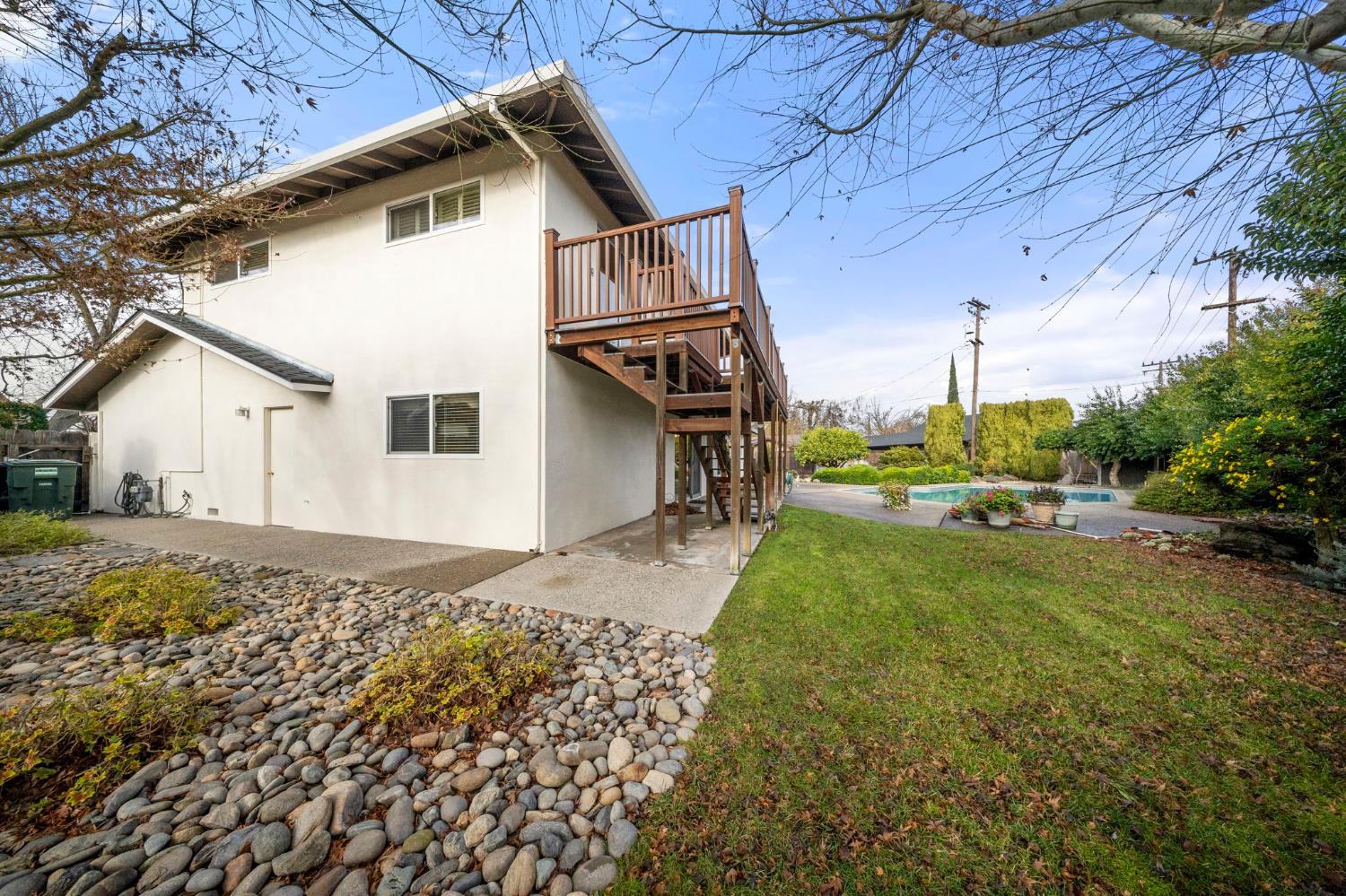 929 Terrace Place Modesto, CA 95350 - Photo 31 of 35 a view of a white house next to a yard with big trees