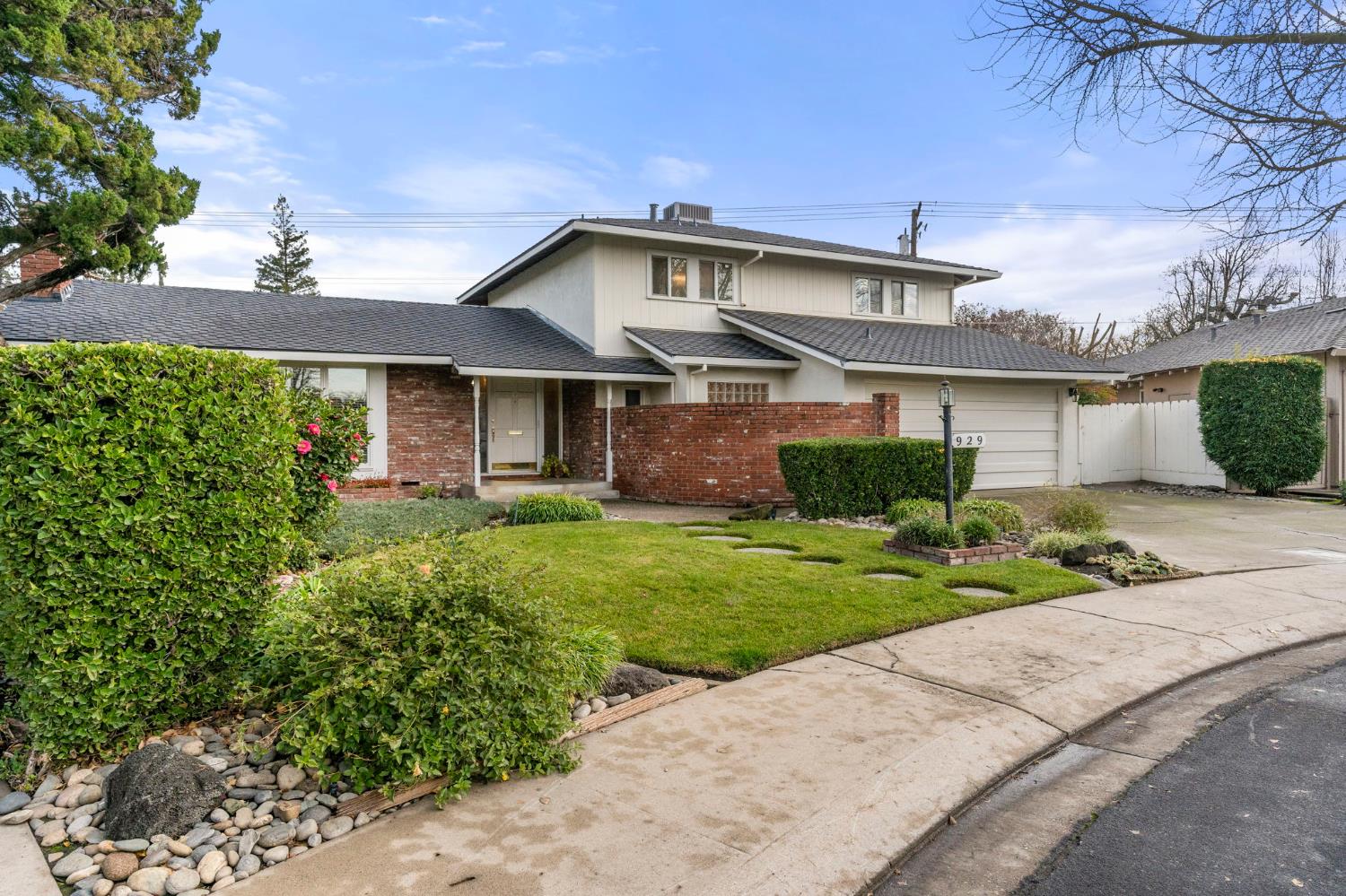 929 Terrace Place Modesto, CA 95350 - Photo 33 of 35 a front view of a house with a yard and potted plants