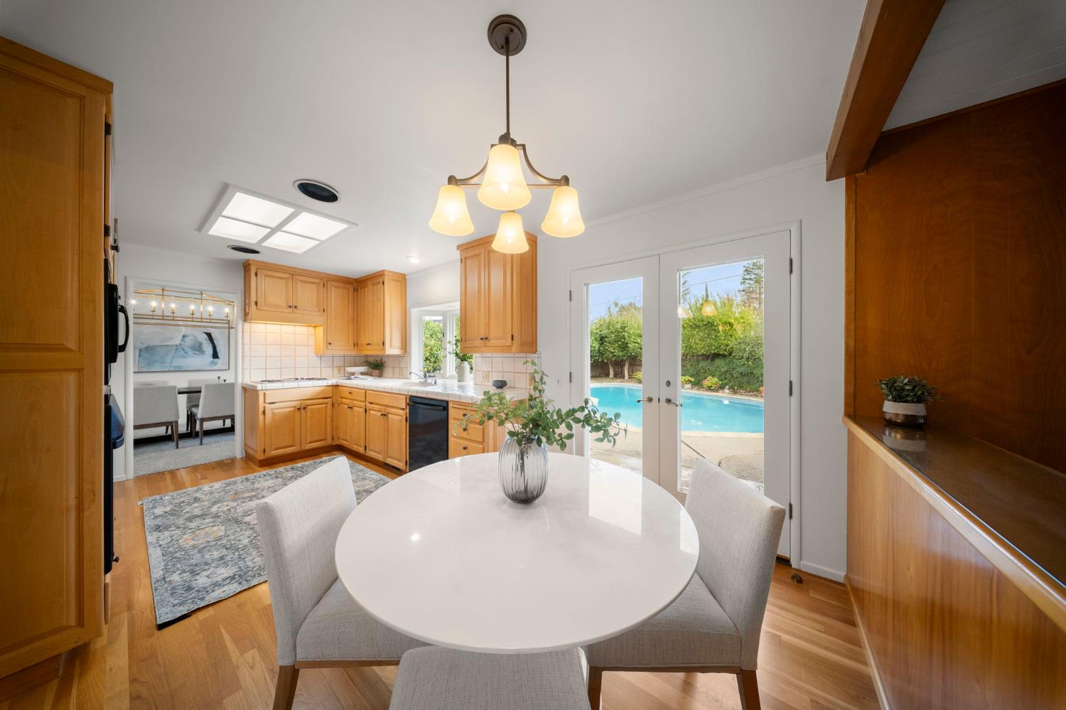 929 Terrace Place Modesto, CA 95350 - Photo 4 of 35 a dining room with furniture a chandelier and a rug