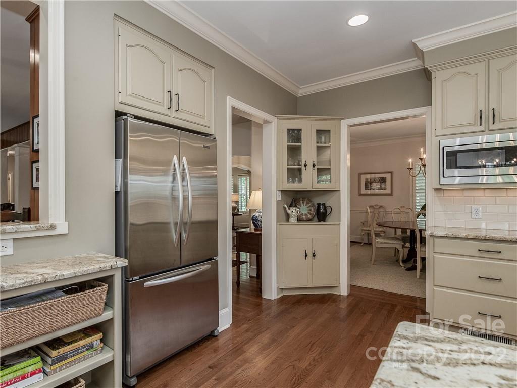 2701 Sharon Road Charlotte, NC 28211 - Photo 15 of 40 a kitchen with stainless steel appliances a refrigerator stove and cabinets