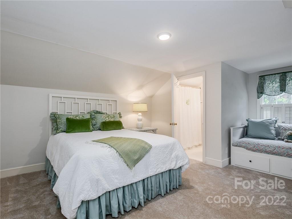 2701 Sharon Road Charlotte, NC 28211 - Photo 22 of 40 a bedroom with a bed and a couch